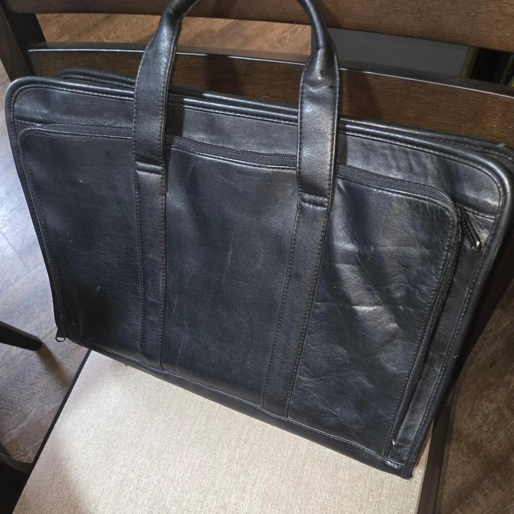 Black leather briefcase with multiple compartments and a sleek design #professio